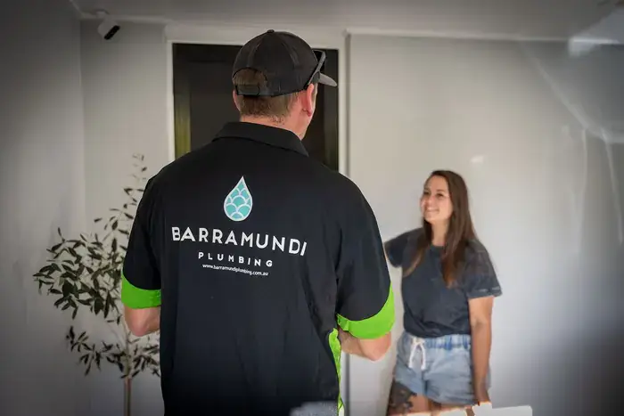Barramundi Plumbing plumber speaking with a happy customer at her front door
