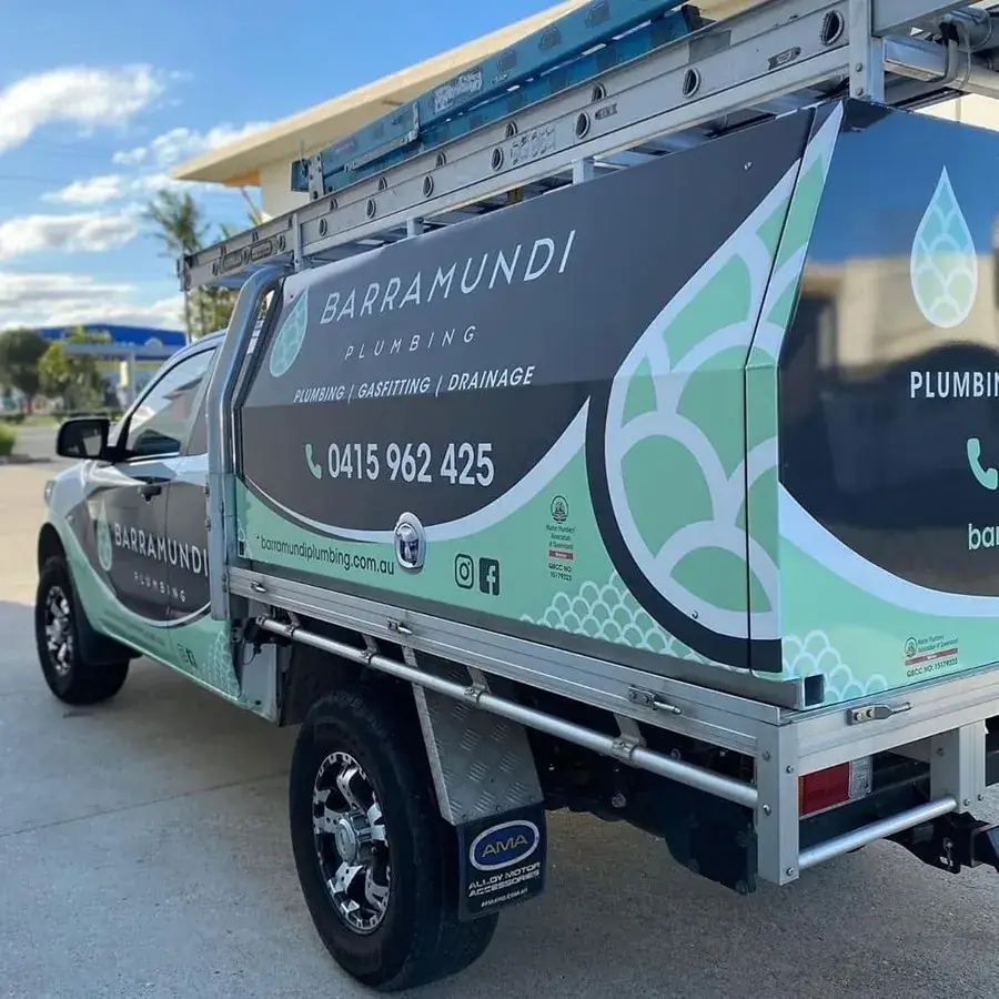Barramundi Plumbing service ute with ladders, signage and phone number